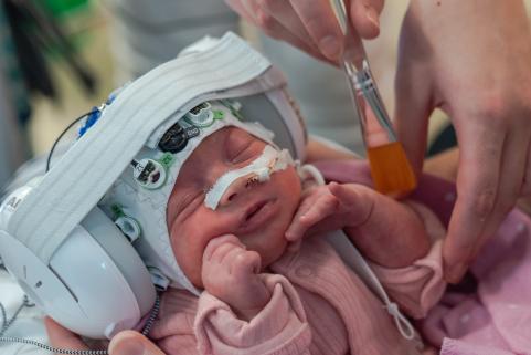 NICU infant wearing EEG cap