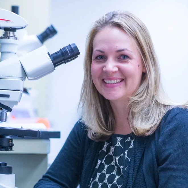 Tajie Harris Headshot with Microscope